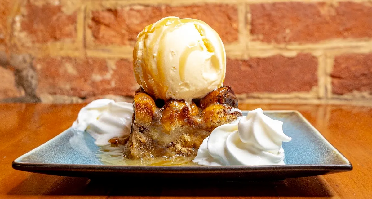 Caramel bread pudding topped with vanilla ice cream