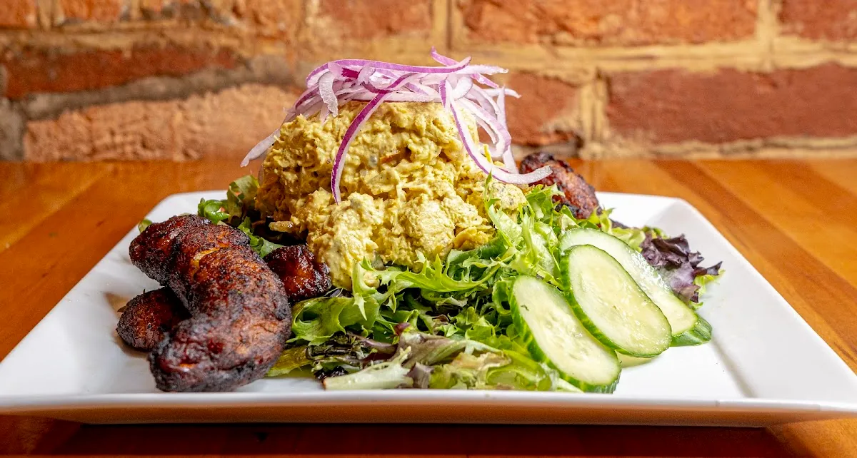 Curry chicken salad over greens with sweet plantains