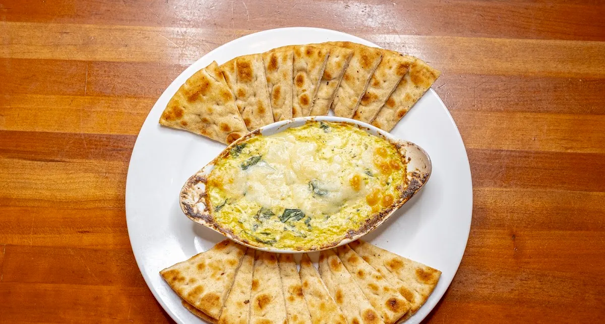 Curry chicken and spinach dip served with pita bread