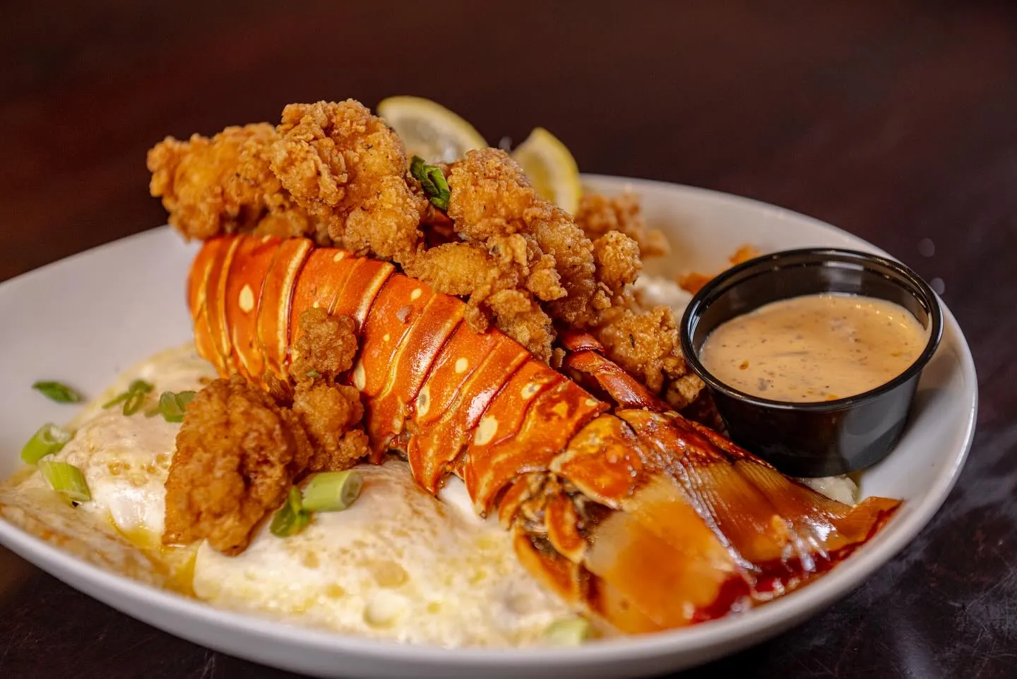 Buttermilk fried lobster tail over creamy grits