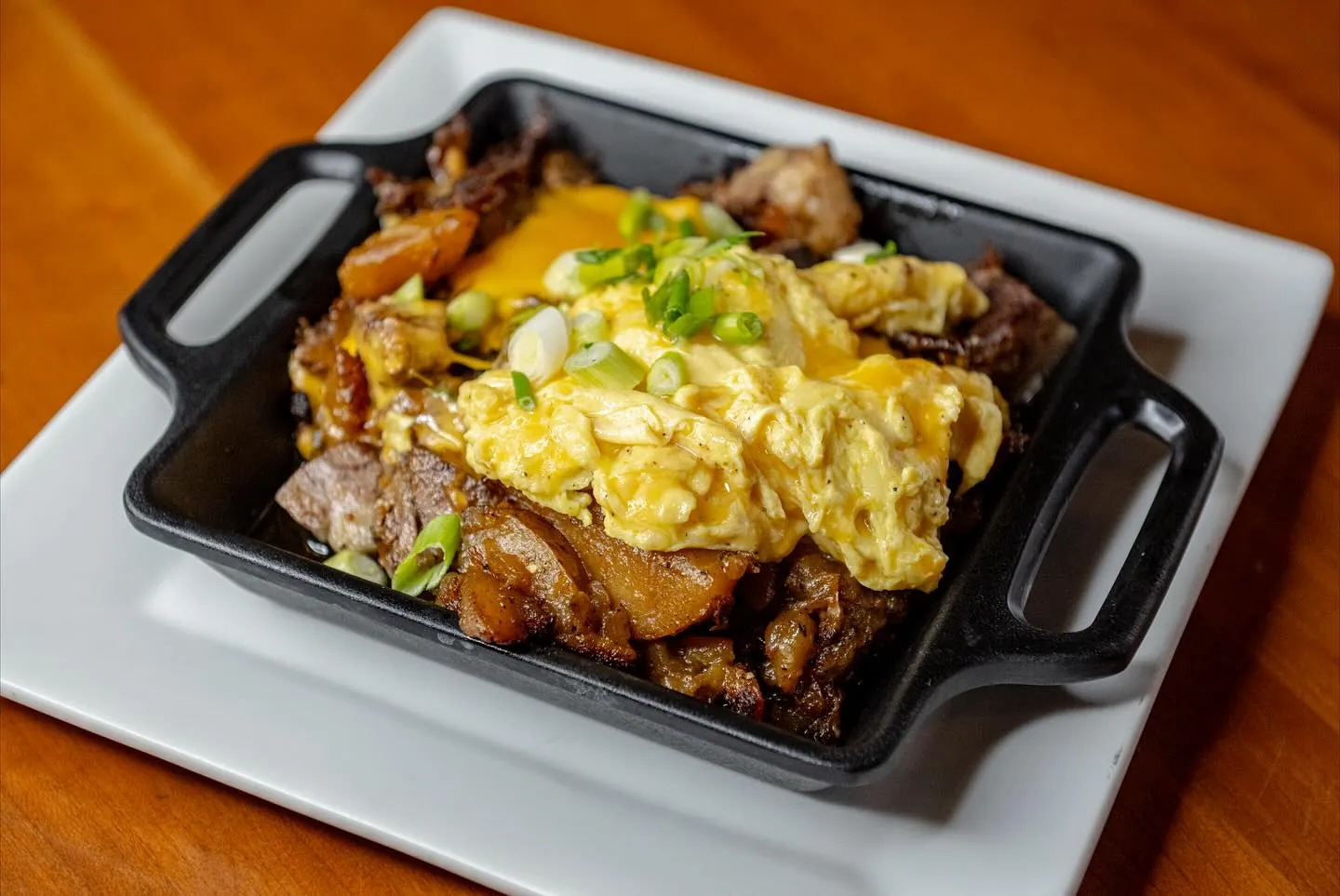 Beef short rib breakfast skillet topped with eggs