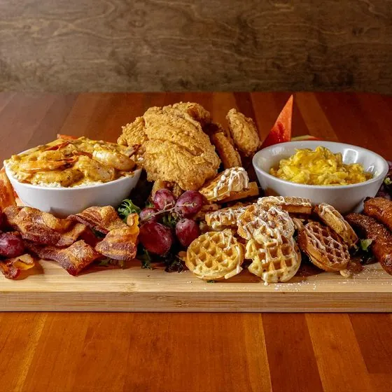 Brunch charcuterie board with waffles and fried chicken